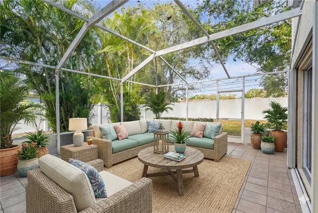 a patio with patio couch and potted plants