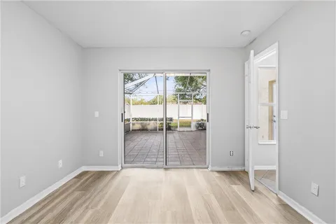 a spacious bathroom with a granite countertop sink a mirror and a bathtub