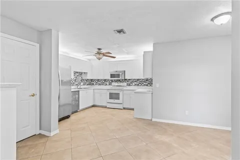 a view of a livingroom with a ceiling fan and window