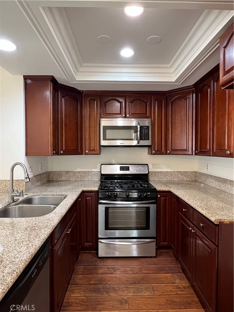 12235 Pine Street, Unit 18 Norwalk, CA 90650 - Photo 1 of 18 a kitchen with stainless steel appliances granite countertop a stove a sink and a microwave