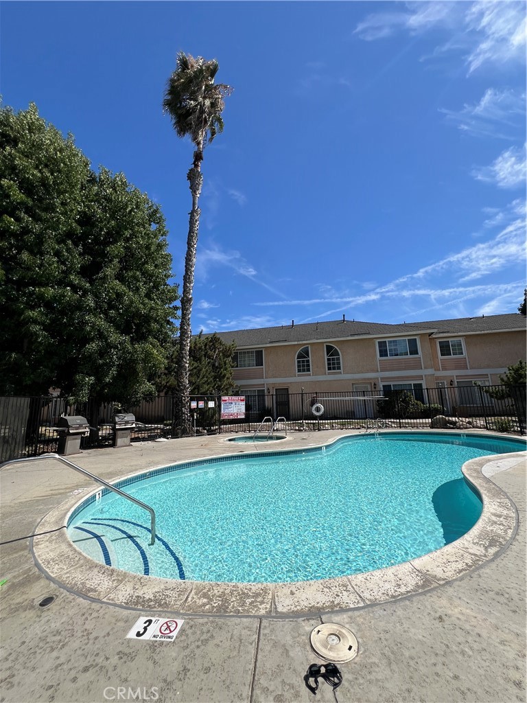 12235 Pine Street, Unit 18 Norwalk, CA 90650 - Photo 15 of 18 a view of a swimming pool with a patio