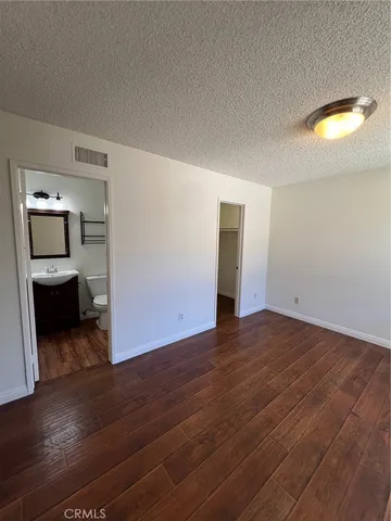 a view of a room with wooden floor and a window