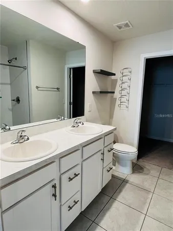 a bathroom with a sink toilet and mirror
