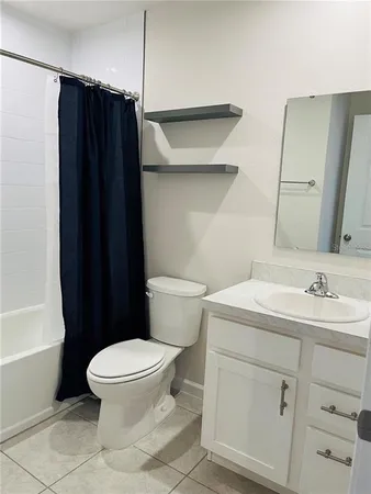a white toilet sitting next to a bathroom sink