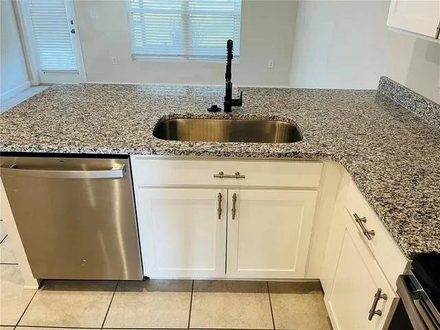 a kitchen with granite countertop a sink and a granite counter tops
