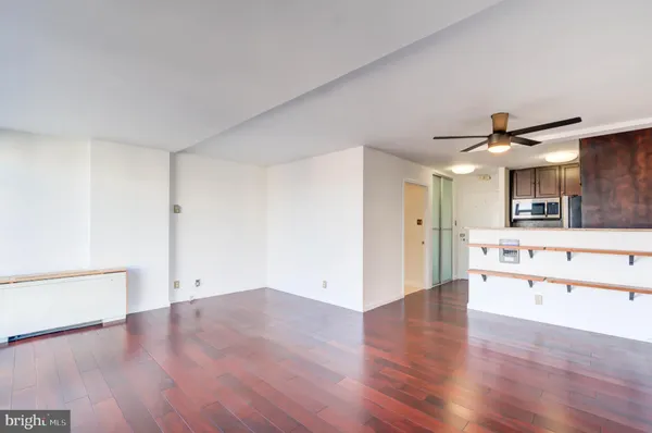 a view of a kitchen with wooden floor and a sink