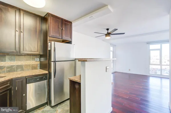 a kitchen with stainless steel appliances a refrigerator and a stove top oven