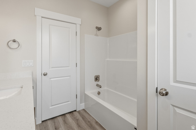 169 West 100 South Joseph, UT 84739 - Photo 24 of 35 Bathroom featuring vanity, light wood finished floors, and shower / tub combination