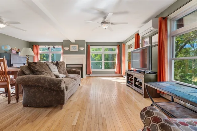 a white bed sitting in a bedroom next to a window