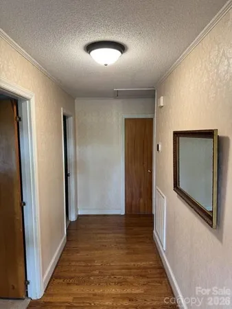 a view of hallway with wooden floor