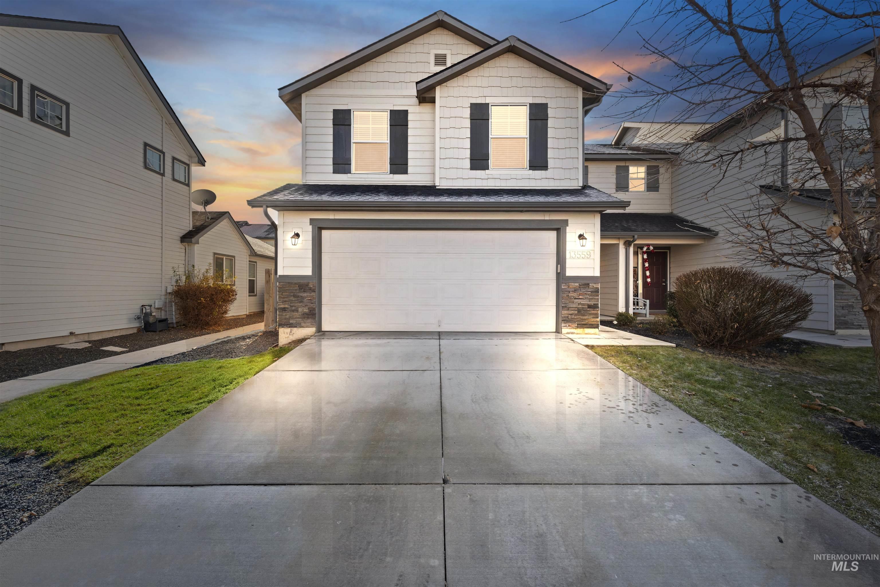 View of front of home featuring driveway and a garage