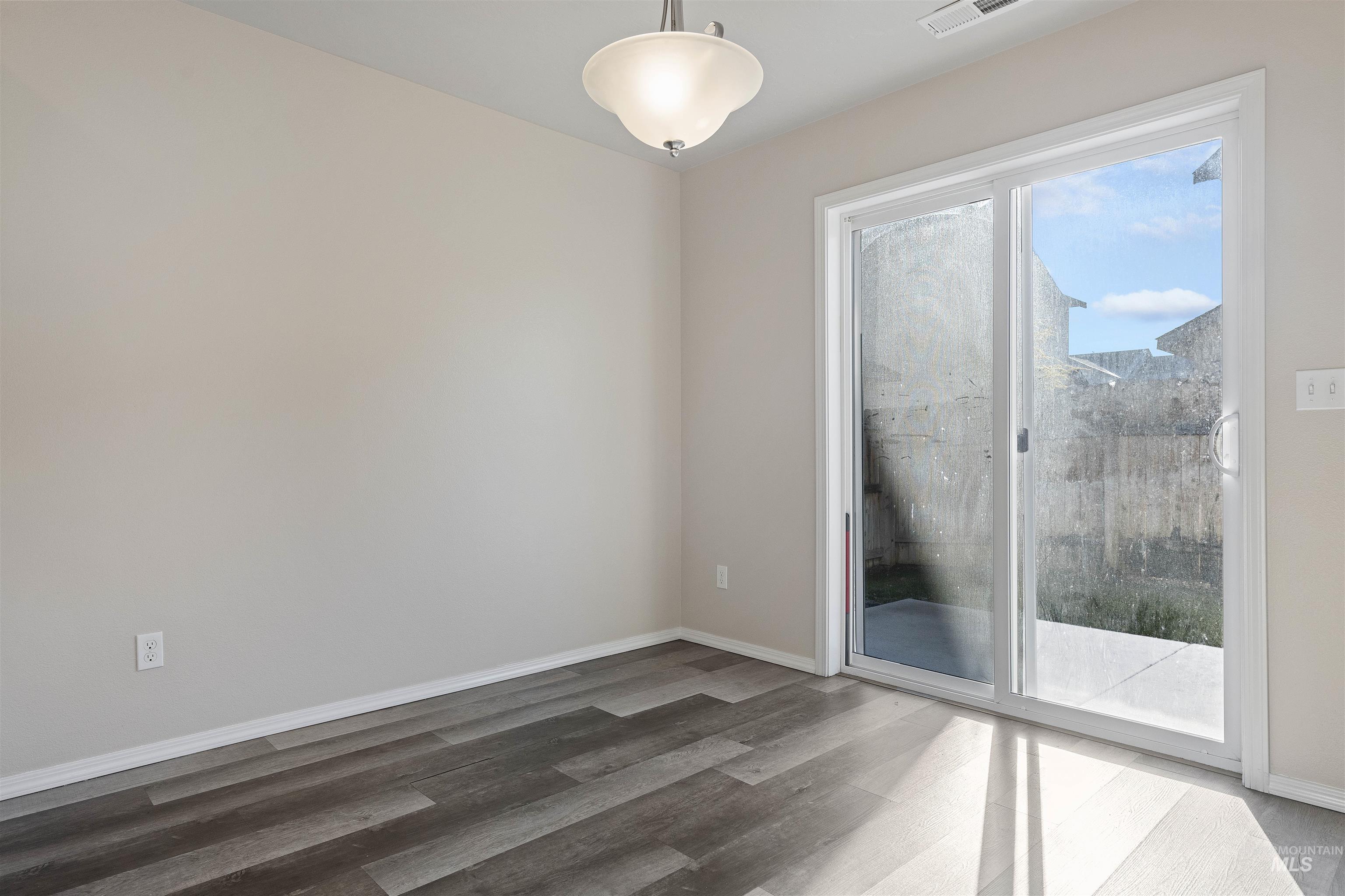13559 Cocoa Beach Way Caldwell, ID 83607 - Photo 12 of 28 Empty room with light wood-type flooring and baseboards