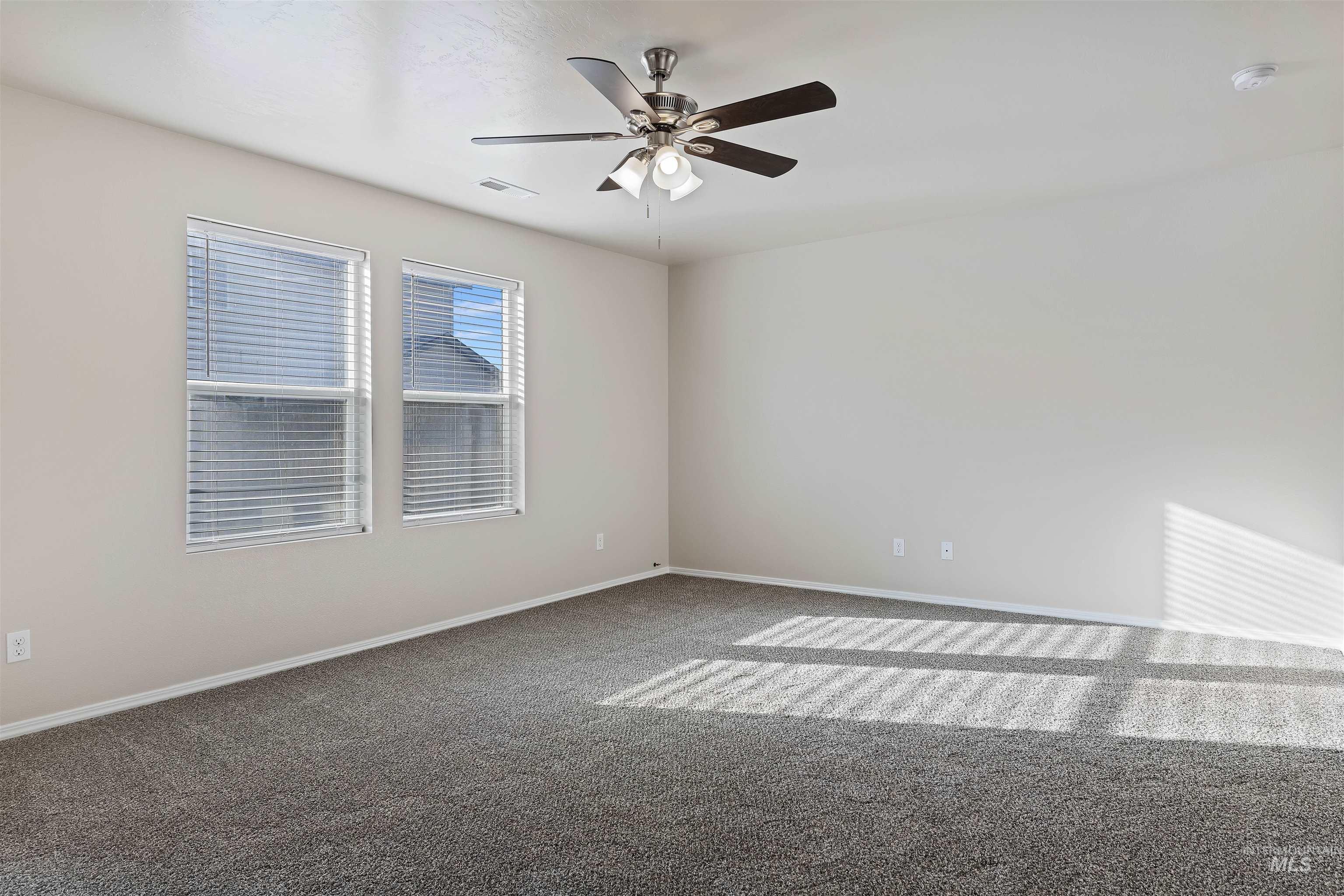 13559 Cocoa Beach Way Caldwell, ID 83607 - Photo 14 of 28 Carpeted spare room featuring baseboards and a ceiling fan