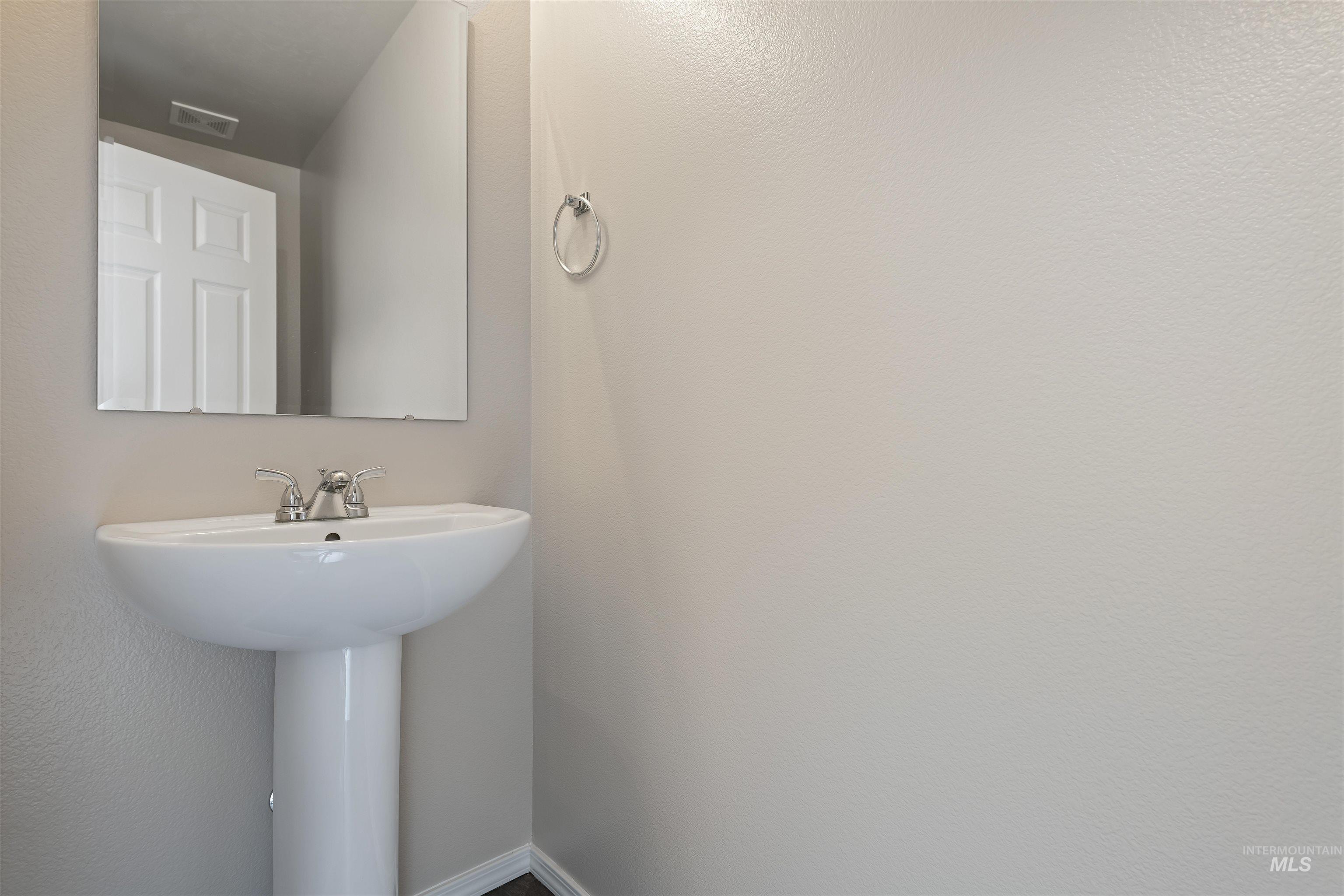 13559 Cocoa Beach Way Caldwell, ID 83607 - Photo 16 of 28 Bathroom featuring a textured wall and a sink