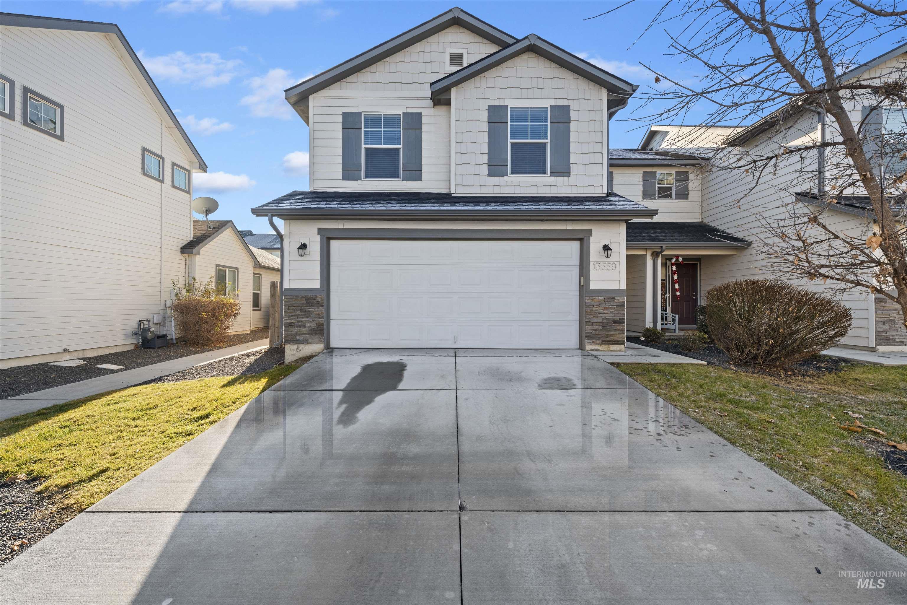13559 Cocoa Beach Way Caldwell, ID 83607 - Photo 2 of 28 View of front of home with driveway, a garage, and stone siding
