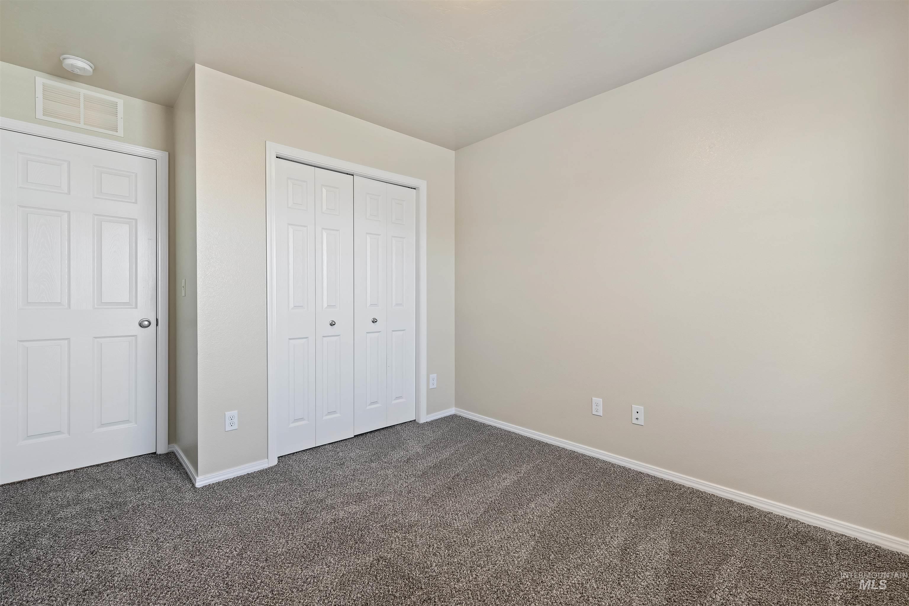 13559 Cocoa Beach Way Caldwell, ID 83607 - Photo 25 of 28 Unfurnished bedroom with dark carpet and a closet