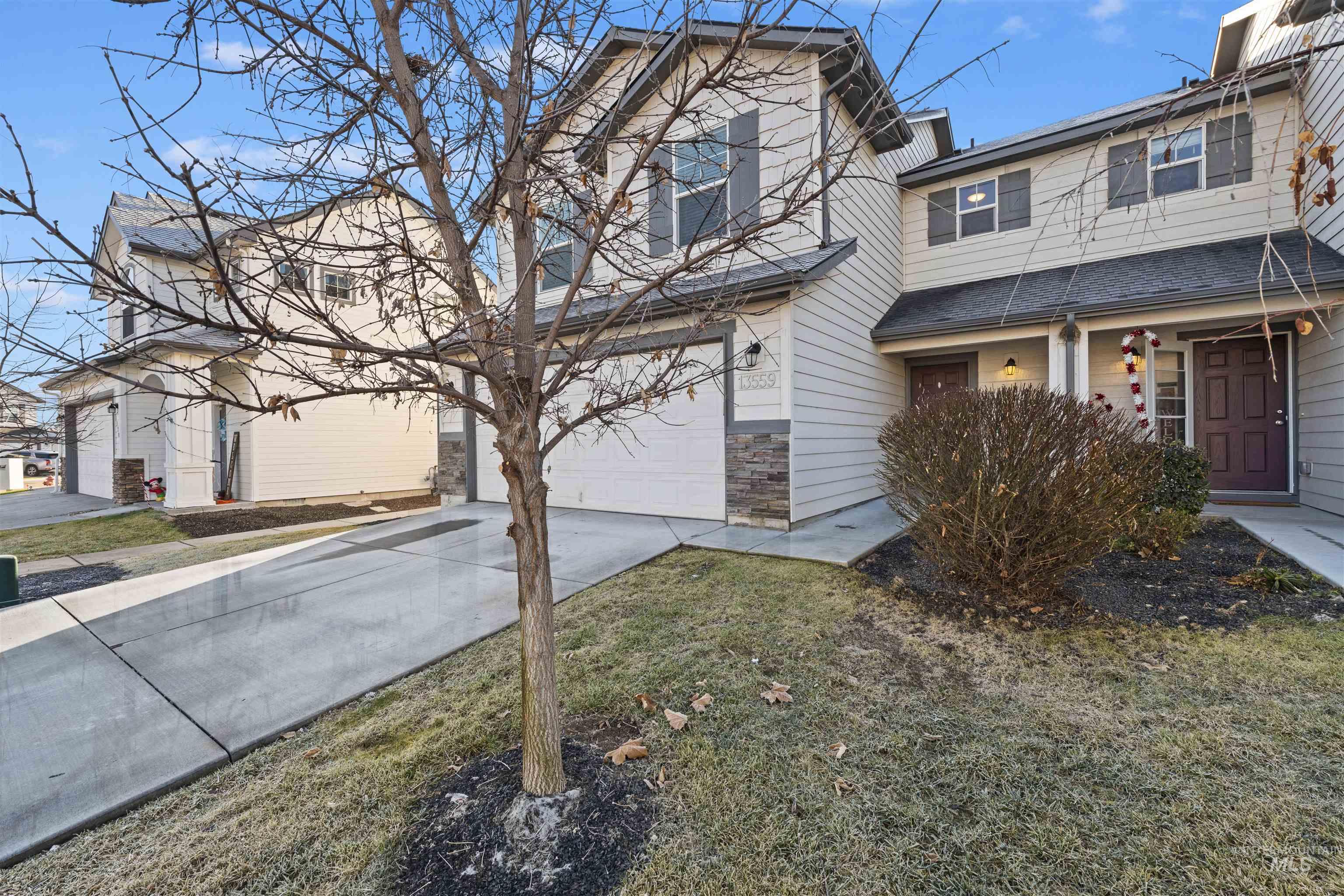 13559 Cocoa Beach Way Caldwell, ID 83607 - Photo 4 of 28 Traditional-style house with driveway, a garage, and stone siding