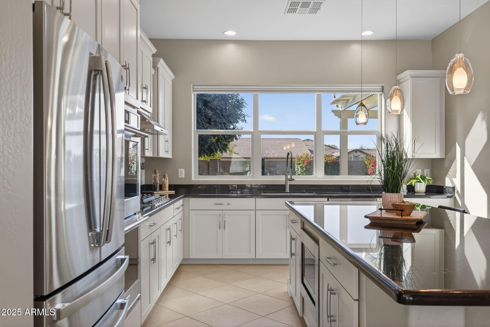 5236 South Excimer Mesa, AZ 85212 - Photo 13 of 85 a kitchen with stainless steel appliances granite countertop a sink and a refrigerator