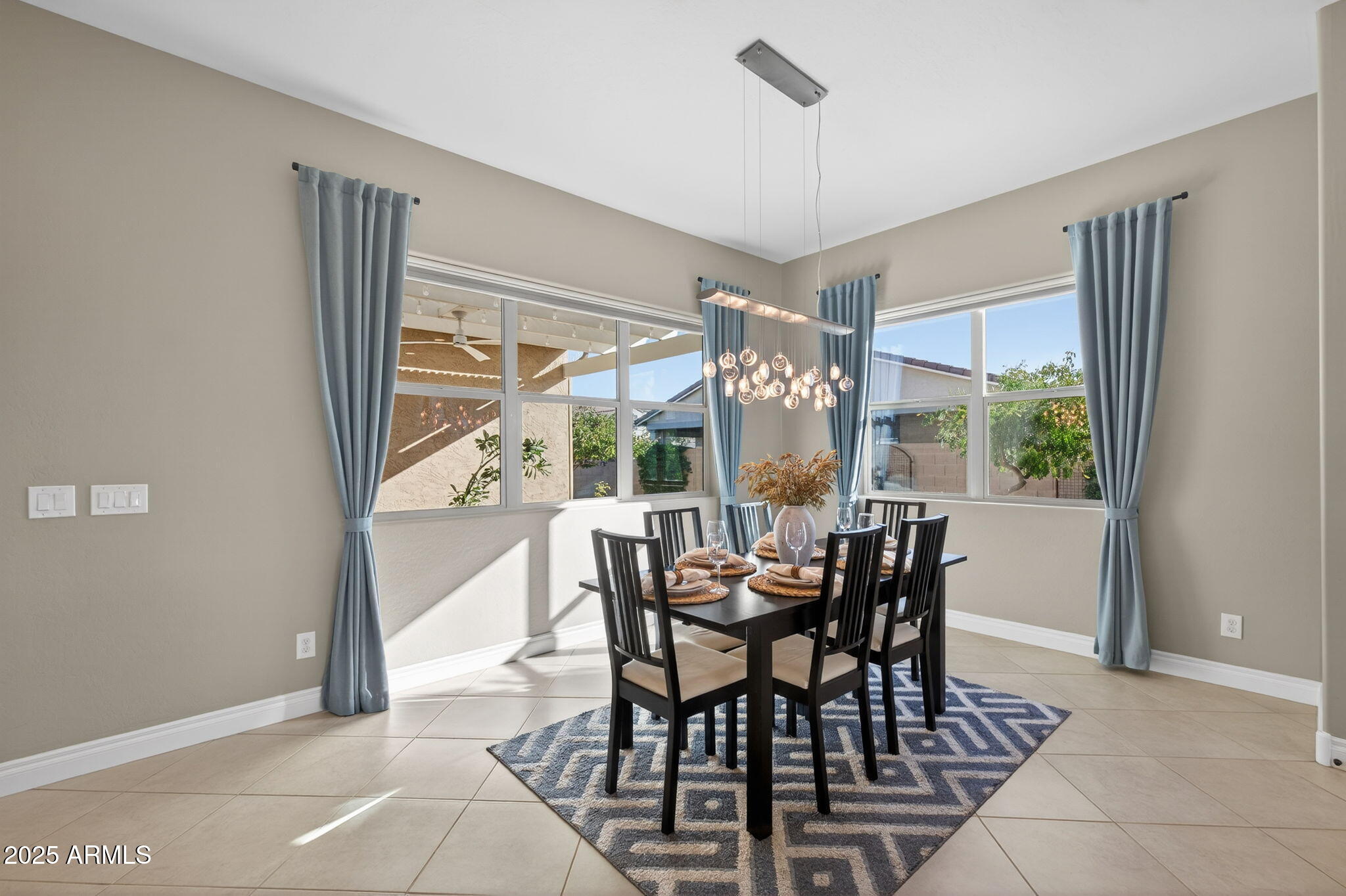 5236 South Excimer Mesa, AZ 85212 - Photo 18 of 85 a view of a dining room with furniture large windows and wooden floor