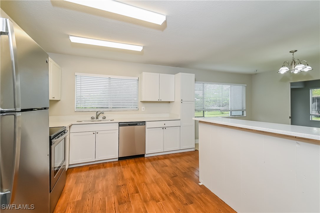 4583 Mongite Road North Port, FL 34287 - Photo 6 of 16 a kitchen with granite countertop white cabinets and white appliances