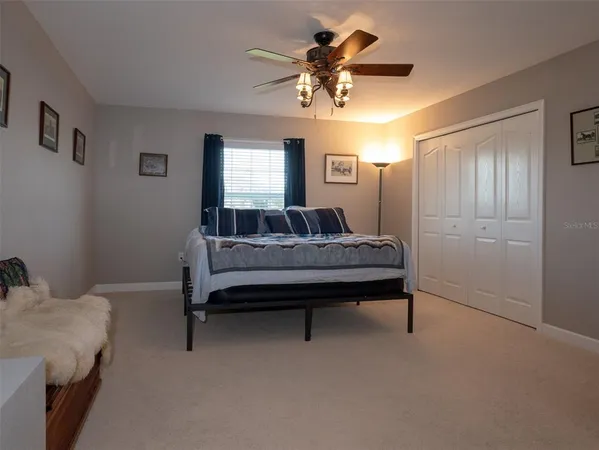 a bathroom with a sink a toilet and a large mirror