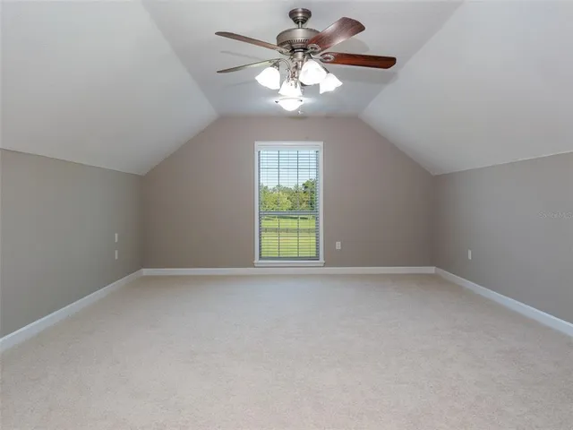 a view of a patio with couches chairs potted plants and a big yard