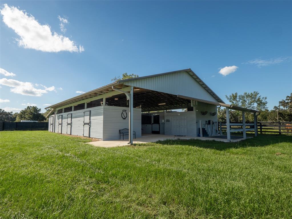 5028 West Anthony Road Ocala, FL 34475 - Photo 24 of 31 a view of a house with a yard and sitting area