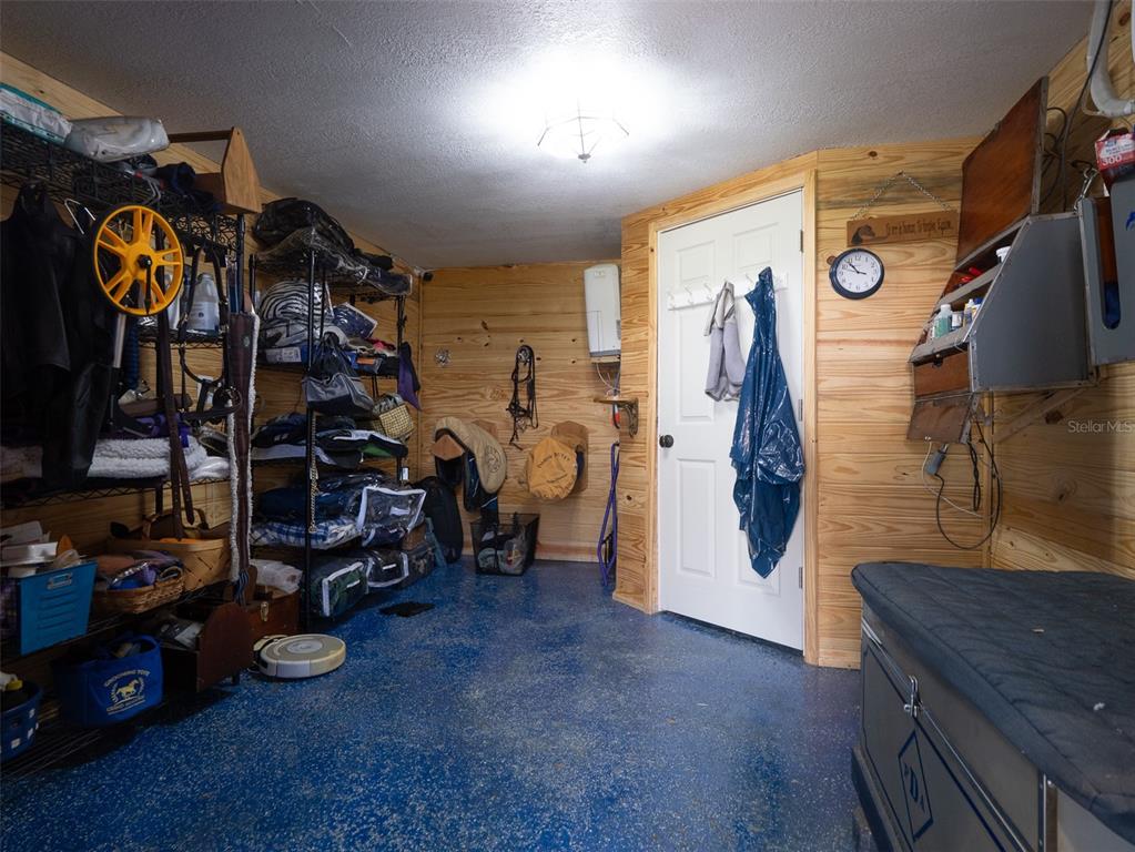 5028 West Anthony Road Ocala, FL 34475 - Photo 27 of 31 a view of walk in closet with clothes and shoes