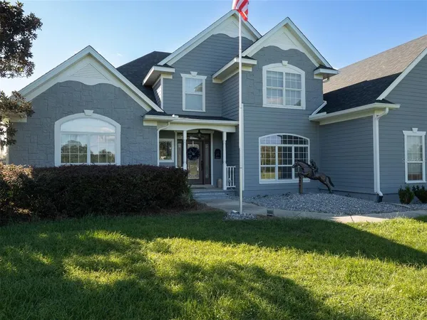 a view of a hallway with wooden floor and stairs