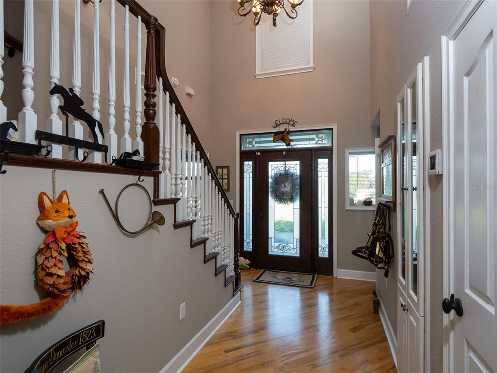 5028 West Anthony Road Ocala, FL 34475 - Photo 4 of 31 a view of a hallway with wooden floor and stairs