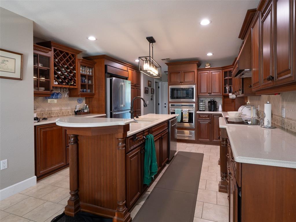 5028 West Anthony Road Ocala, FL 34475 - Photo 8 of 31 a kitchen with stainless steel appliances granite countertop a sink a stove and a refrigerator