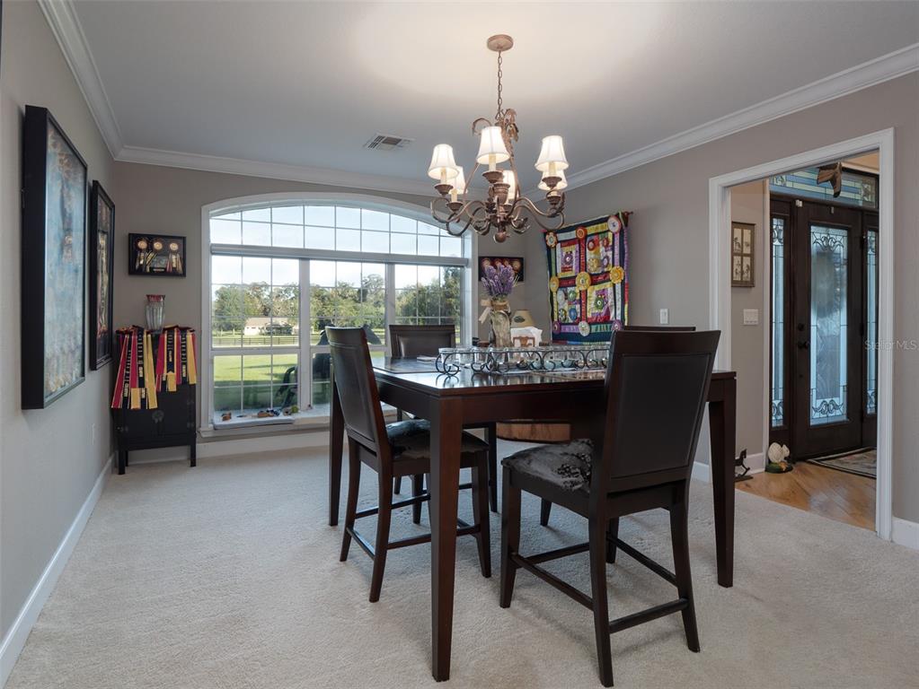 5028 West Anthony Road Ocala, FL 34475 - Photo 10 of 31 a view of a dining room with furniture window and outside view