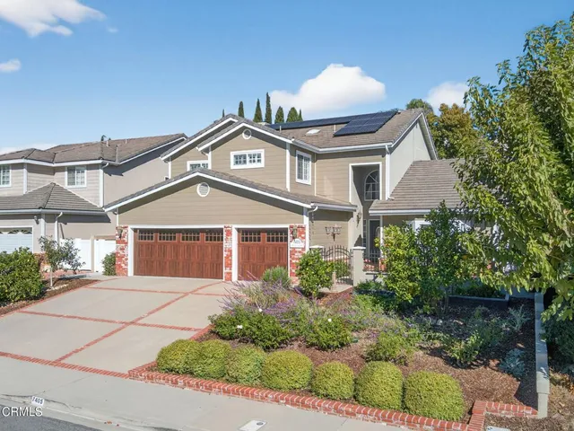 a living room with furniture a chandelier and a fireplace