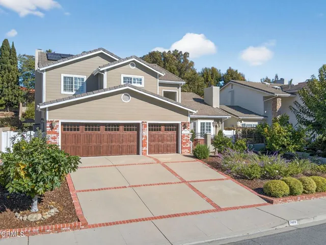 a living room with furniture kitchen view and a potted plant