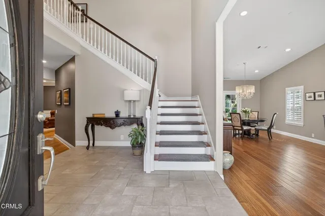 a view of a dining room with furniture a chandelier and wooden floor