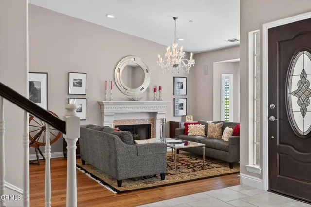 a dining room with furniture a chandelier and wooden floor