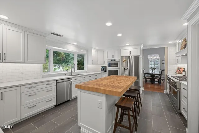 a spacious bathroom with sinks mirror and a bathtub