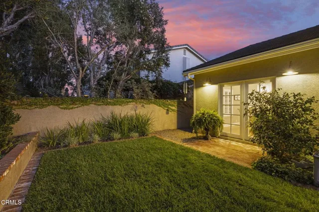 a view of a patio with table and chairs and potted plants