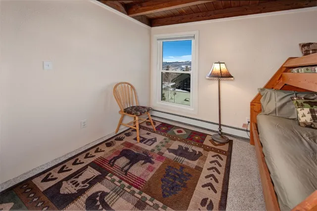 a bed sitting in a bedroom next to a lamp