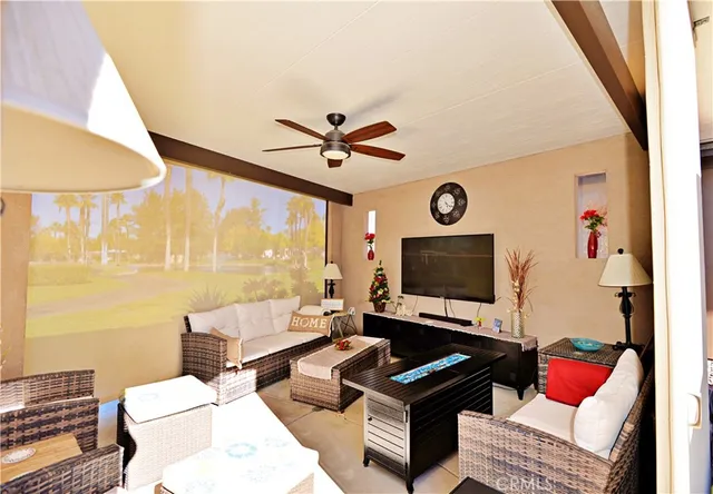 a living room with furniture a rug and a window