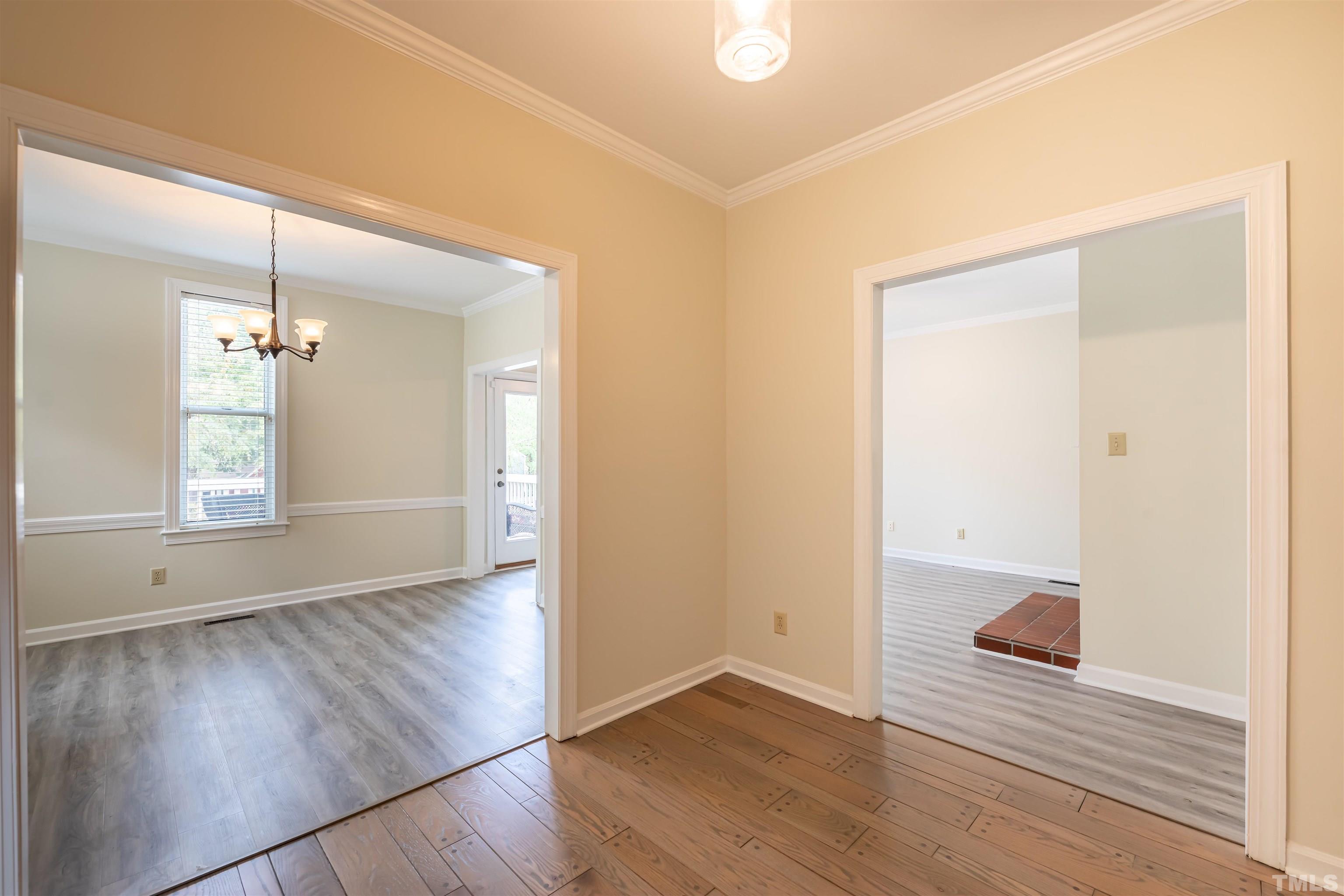 5810 Sentinel Drive Raleigh, NC 27609 - Photo 5 of 11 an empty room with wooden floor and window