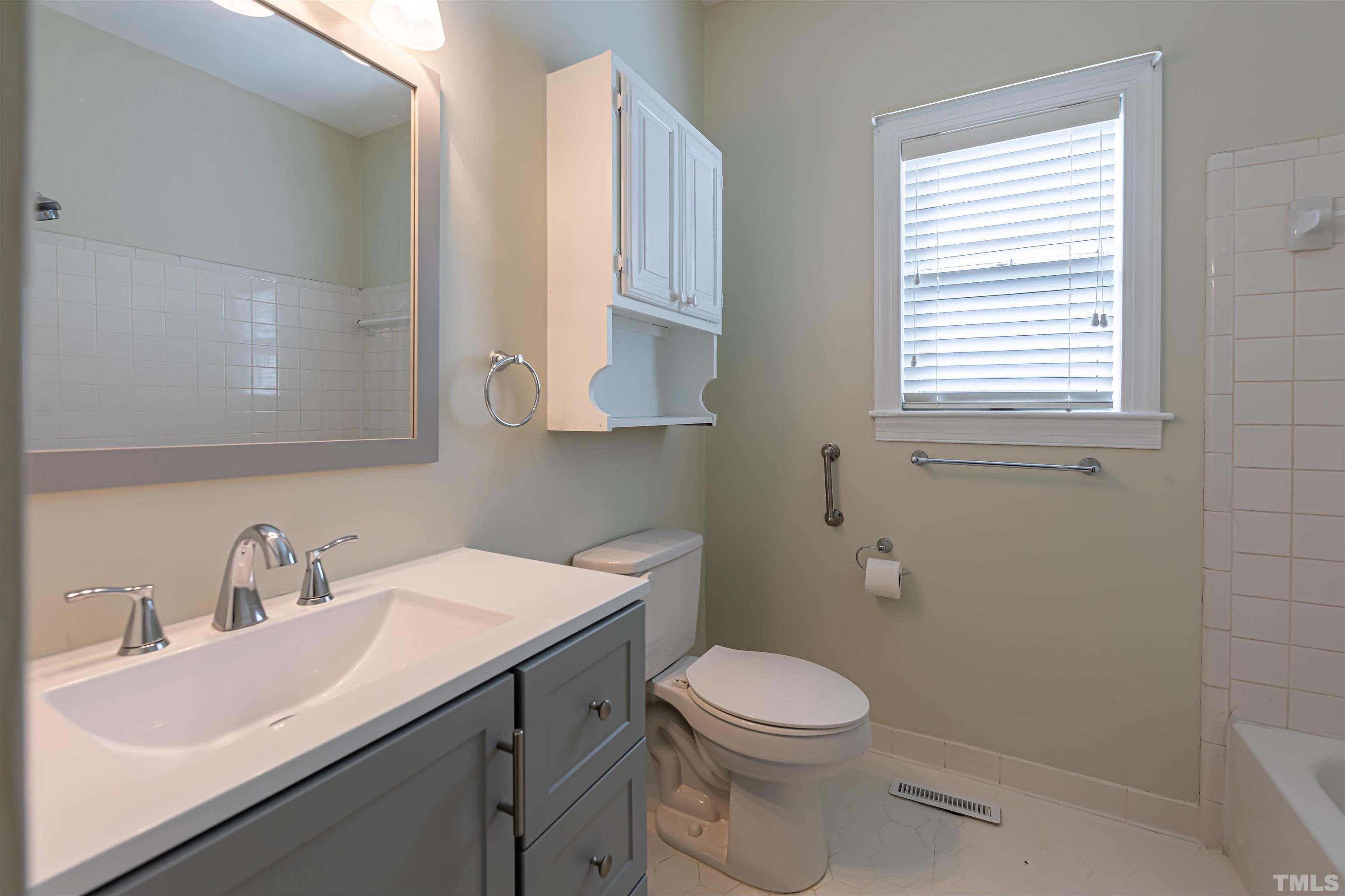 5810 Sentinel Drive Raleigh, NC 27609 - Photo 7 of 11 a bathroom with a sink a toilet and a window