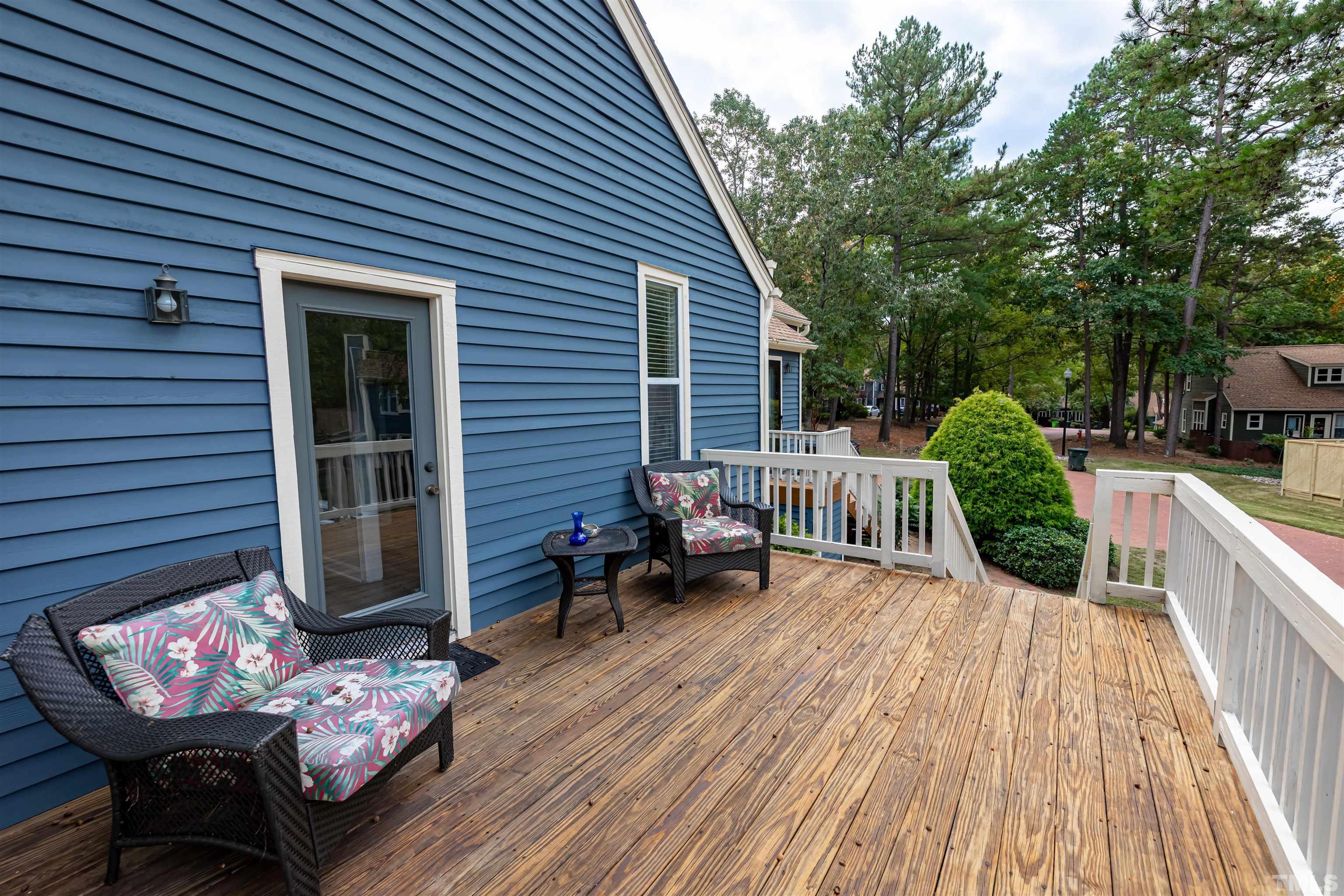 5810 Sentinel Drive Raleigh, NC 27609 - Photo 8 of 11 a view of a deck with couches table and chairs and potted plants