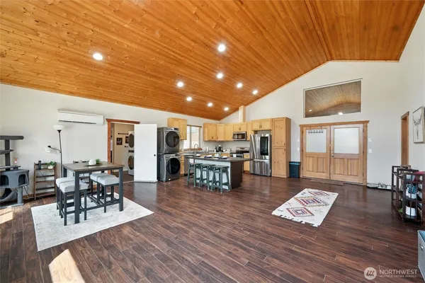 a kitchen with granite countertop a table chairs stove and refrigerator