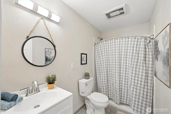 an aerial view of a house with pool and trees