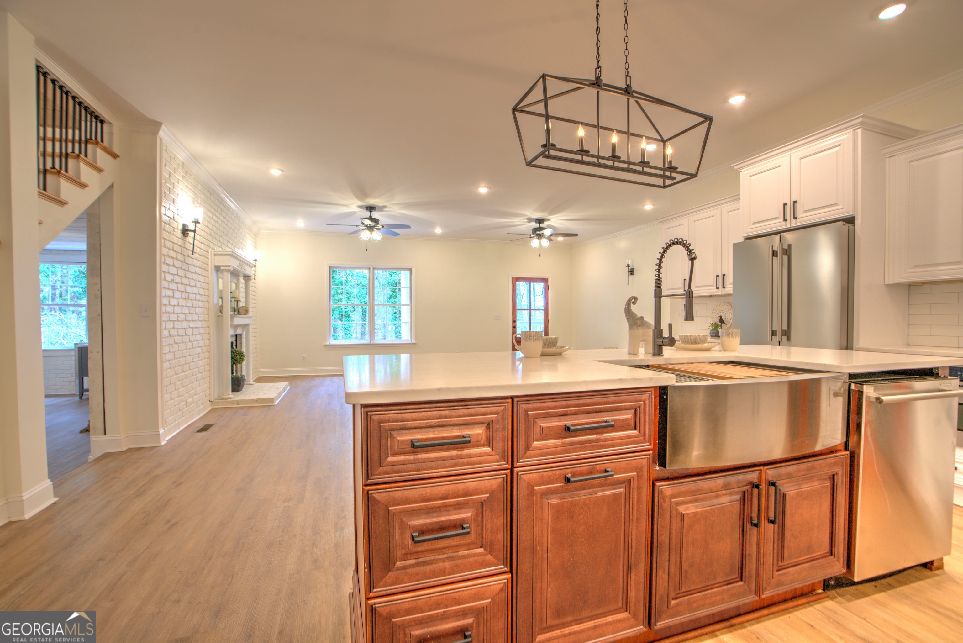 205 Mt Alto Road Southwest Rome, GA 30165 - Photo 11 of 36 a kitchen with stainless steel appliances granite countertop a refrigerator a sink dishwasher a dining table and chairs with wooden floor