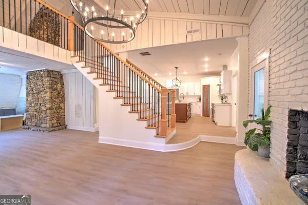 a view of entryway and hall with wooden floor
