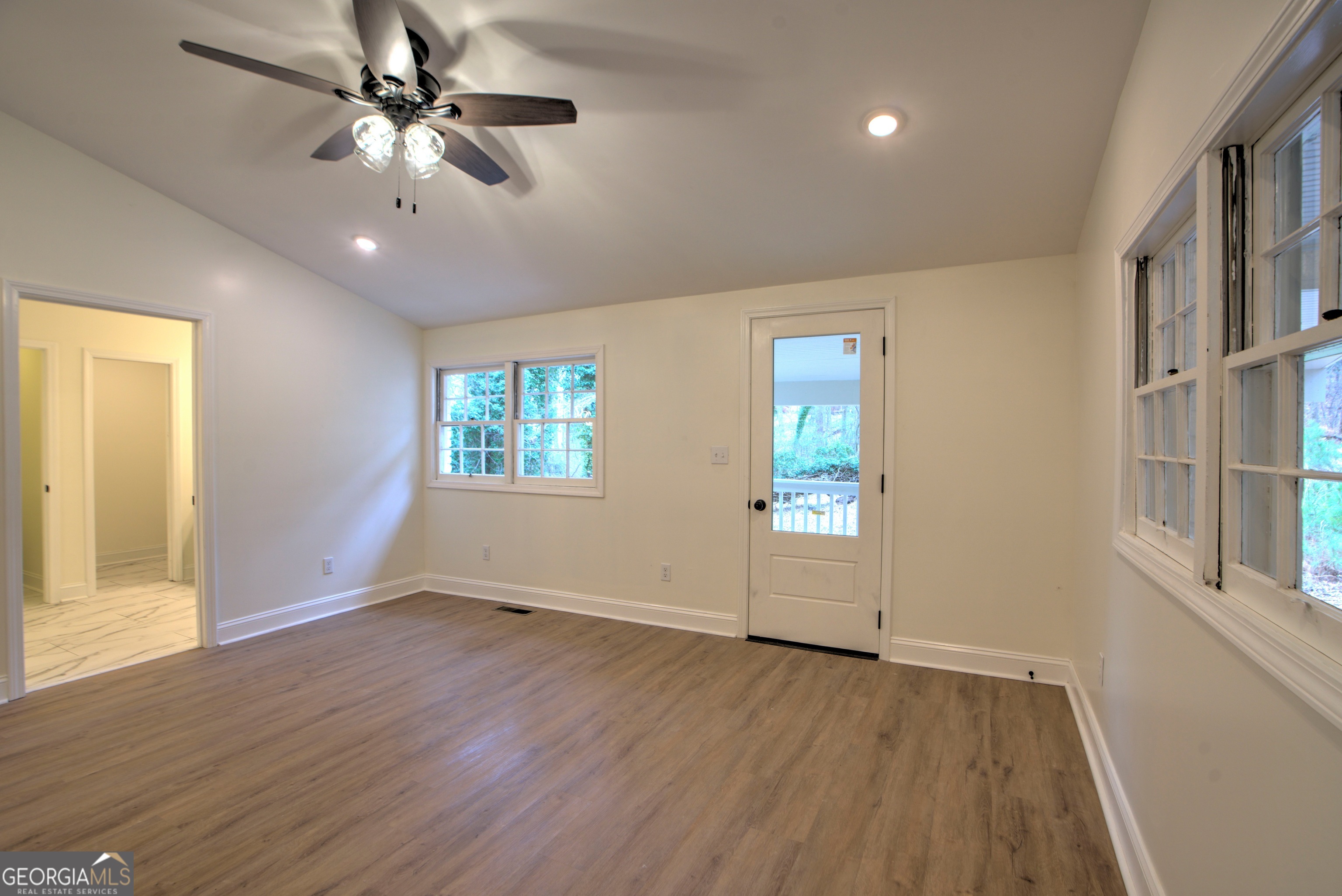 205 Mt Alto Road Southwest Rome, GA 30165 - Photo 15 of 36 an empty room with wooden floor chandelier fan and windows