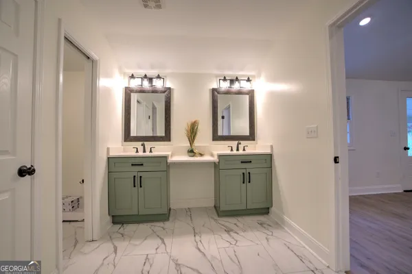 a spacious bathroom with a double vanity sink and a mirror