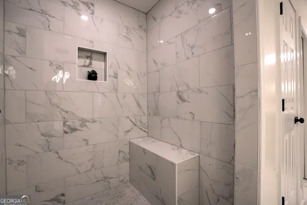 a bathroom with a shower and a mirror